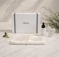 SilkyBare gift box with an off-white silk pillowcase, Youthful Glow Face Oil and White Quartz Gua Sha