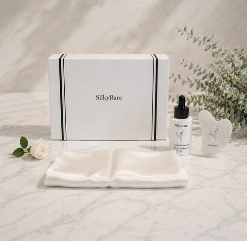 SilkyBare gift box with an off-white silk pillowcase, Youthful Glow Face Oil and White Quartz Gua Sha